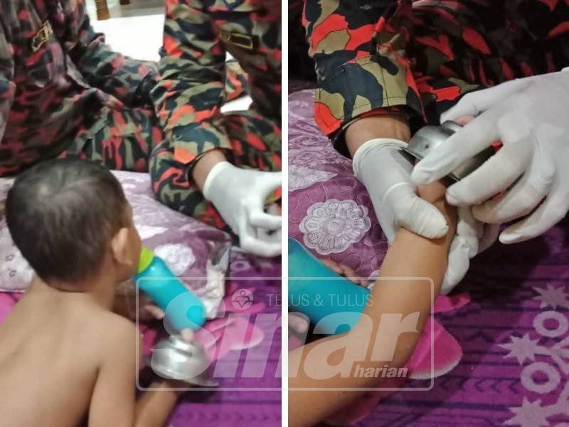 Kanak-kanak itu ditenangkan anggota BBP Batu Arang sebelum operasi mengeluarkan jari mangsa dilakukan.