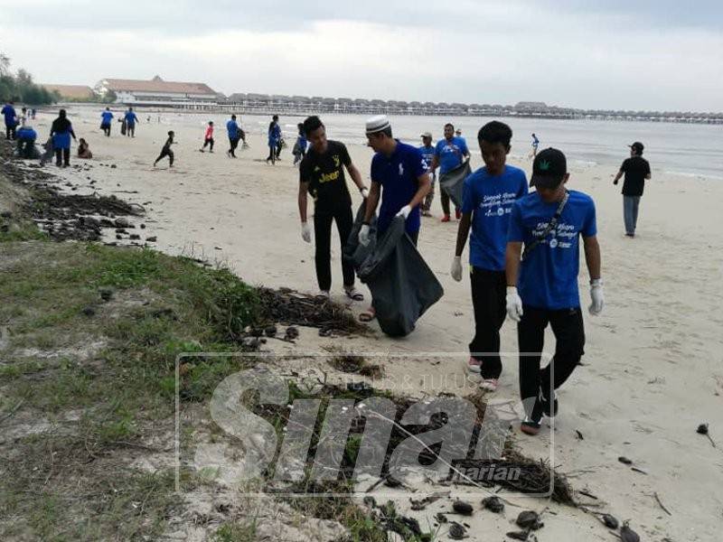 Peserta Singgah Mesra Perangsang Selangor bekerjasama mengutip sampah di Pantai Bagan Lalang.