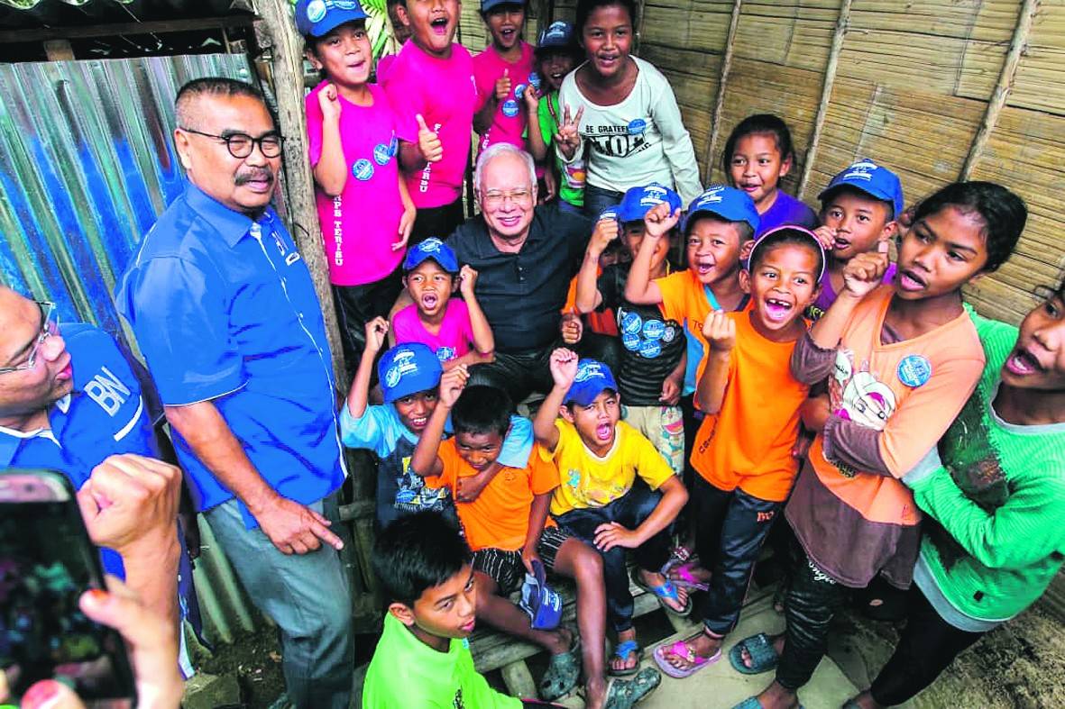 Najib bersama Rahim (kiri) ketika berkempen di Kampung Terisu, Cameron Highlands, baru-baru ini.