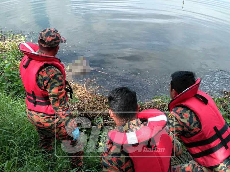Anggota bomba ketika mengeluarkan mayat mangsa yang ditemui terapung di sebuah lombong di Kampung Baru Kanthan, hari ini.