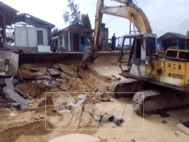 Jengkaut digunakan untuk meletakkan benteng pasir di kawasan hakisan.