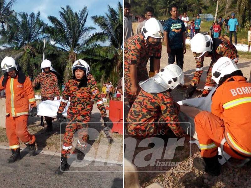 Anggota bomba membantu mengangkat mayat mangsa sebelum dihantar ke Hospital Pekan.