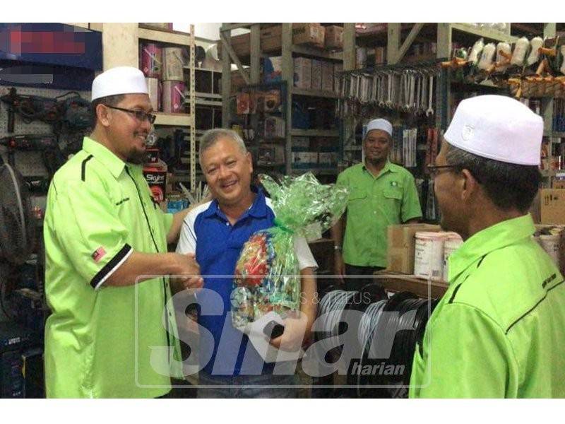 Mujibur (kiri) bersalaman dan menyantuni warga Tiong Hia Dun Chenor.