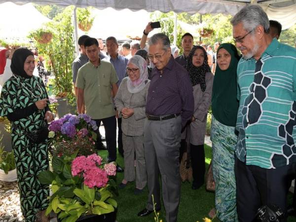 Perdana Menteri Tun Dr Mahathir Mohamad (tiga,kanan) mendengar penerangan daripada Pengarah Urusan SeriGreen Garden and Landscape Sdn Bhd Jamaliah Hamdan (kiri) ketika melawat pameran bunga orkid pada Majlis Sambutan Hari Landskap Negara 2019 bertemakan "Malaysia Negara Taman Terindah" di Taman Botani hari ini. Turut kelihatan Menteri Wilayah Persekutuan Khalid Abd Samad (kanan) dan Ketua Pengarah Jabatan Landskap Negara Rotina Daik (lima, kanan). - Foto Bernama