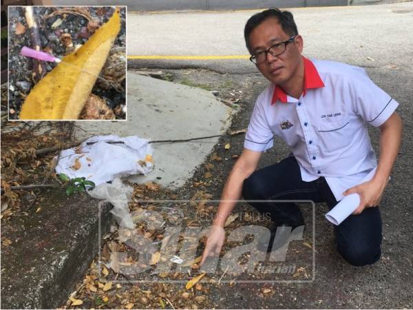 Exco Kesihatan dan Anti Dadah negeri Low Chee Leong menunjukkan jarum suntikan yang ditemui dalam keadaan bersepah di belakang sebuah bangunan di Jalan Ong Kim Wee.