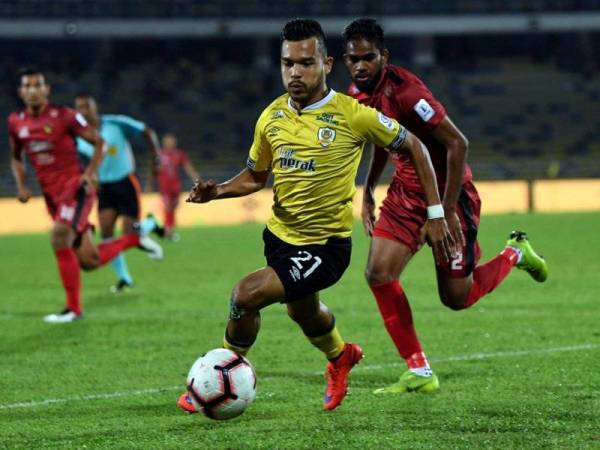 Pemain Perak, Nazirul Naim Che Hashim (depan) mengawal bola ketika bertemu pasukan Negeri Sembilan pada saingan Piala FA Malaysia di Stadium Perak. - Foto Bernama