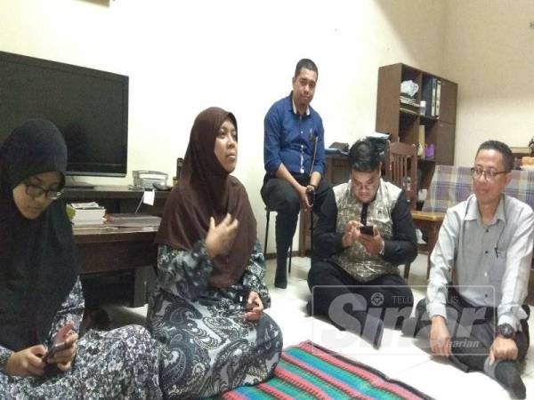 Aslinda (dua dari kiri) berkongsi cerita mengenai arwah suaminya ketika lawatan Perkeso Selangor dan wakil Parlimen Shah Alam ke rumahnya, hari ini.