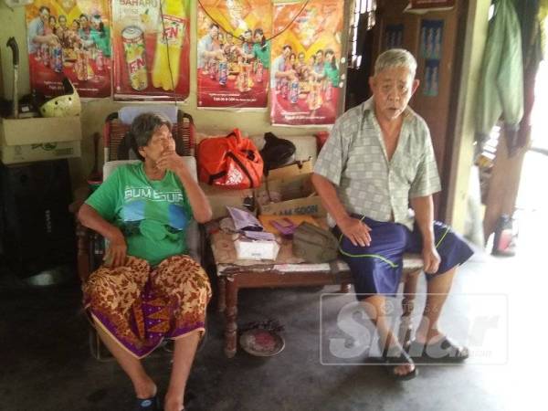 Rosli (kanan) dan Faridah berteduh di bangsal tokong setelah dihalau keluar dari rumah mereka. 