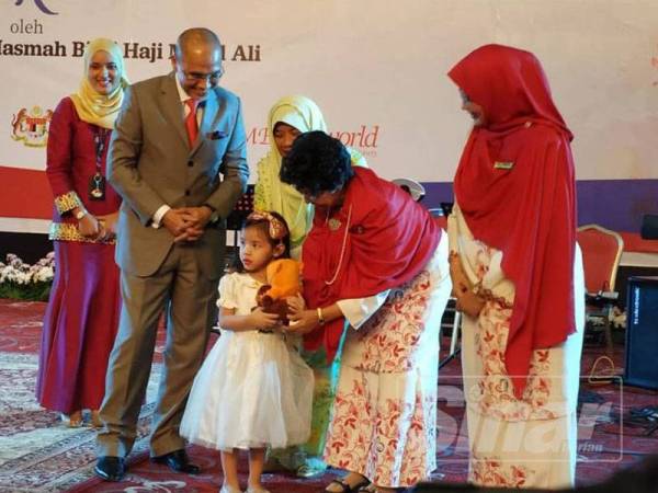 Dr Siti Hasmah (dua dari kanan) memberi cenderamata kepada kanak-kanak dalam majlis pelancaran Program Sinar Kasih.