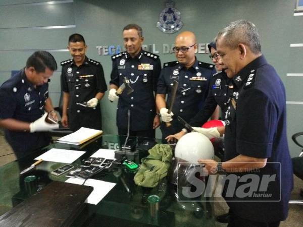 Mohd Noor (tiga dari kiri) bersama pegawainya menunjukkan barang rampasan susulan penahan anggota Geng Panjang pada sidang medianya di sini hari ini.