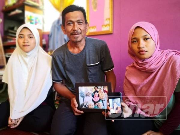 Amir Shariffuddin menunjukkan gambar anak perempuannya itu yang kini dirawat di Hospital Selayang.