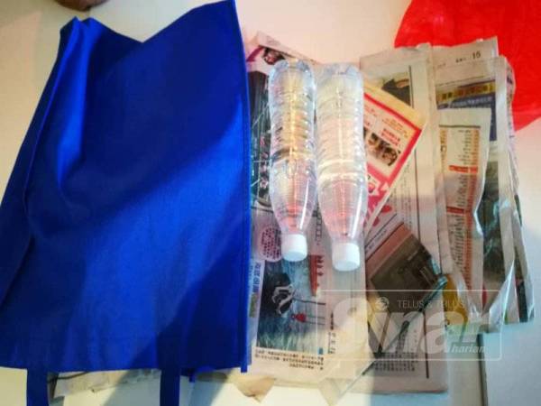 Suspek menukar beg berisi wang tunai dan barangan kemas milik Tan dengan dua botol air mineral yang dibalut kertas surat khabar.