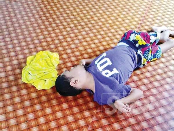 Zaiton menjaga Wan Ahmad Muzamil yang tidak boleh berjalan sejak lahir.