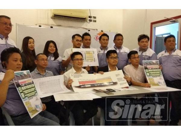 Howard (duduk, dua kanan) dan Kah Woh (duduk) tengah menunjukkan lukisan cadangan bangunan pasar baharu yang dicadang untuk dibina jika referendum tersebut bersetuju. 