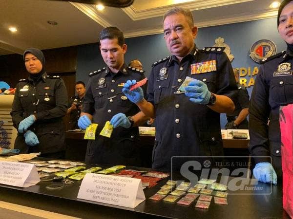 Norzainy (dua dari kanan) menunjukkan dadah yang dirampas dari tiga serbuan di Butterworth dalam tempoh 24 jam.