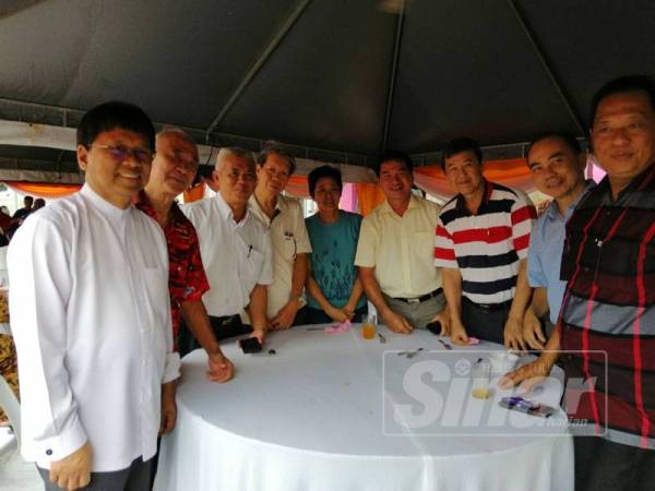 Asmuni (kanan) menyantuni komuniti Cina yang hadir Rumah Terbuka Aidilfitri Amanah Perak hari ini.