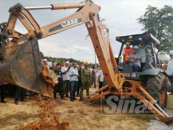 Ahmad Samsuri menyempurnakan gimik perasmian Majlis Pecah Tanah Projek Perumahan RMM Tajin di Kampung Tajin, Hulu Terengganu hari ini.