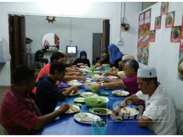 Orang ramai menikmati sup kepala ikan di Restoran Sup Kepala Ikan Mok Ambo.