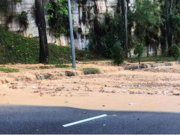 Limpahan banjir kilat dari tapak pembinaan masuk ke atas jalan raya berhampiran Penchala Link petang tadi. - Foto JBPM KL