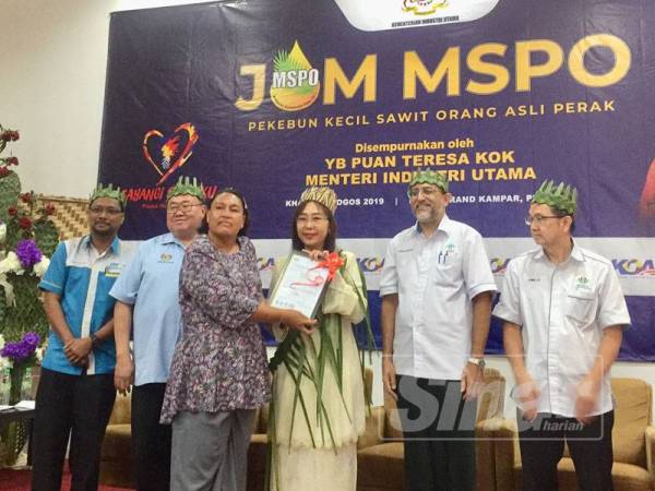 Teresa (tiga dari kanan) menyampaikan MSPO kepada salah serang peserta orang asli di Perak pada majlis berkenaan hari ini.