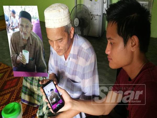 Shaharin (kiri) dan anaknya Haziq Shauki menunjukkan gambar mangsa. Gambar kecil: Mat Zain.