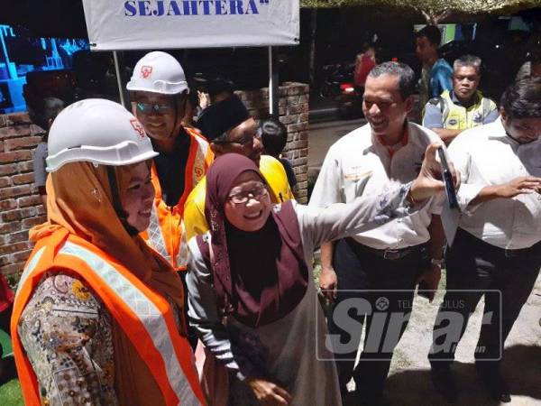 Masyarakat tidak melepaskan peluang bergambar bersama Menteri Pembangunan Luar Bandar, Datuk Seri Rina Harun pada Majlis Pelancaran Pemasangan Lampu Jalan Kampung jenis LED dari Dana IBR bertempat di Kampung Rinching Hilir, Mukim Beranang, Hulu Langat di sini semalam.