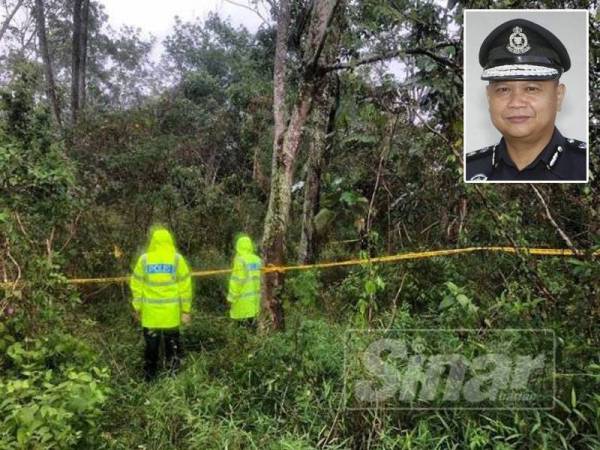 Anggota polis menjalankan siasatan penemuan tengkorak manusia dalam kebun getah. Gambar kecil: Ahmad Adnan