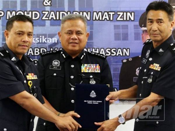 Abdul Jalil (tengah) menyaksikan serah terima tugas Mohd Razli (kanan) dan timbalannya, Mohd Zaidi di Ibu Pejabat Polis Daerah (IPD) Pekan di sini hari ini.