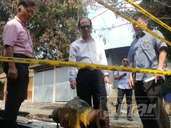 Tengku Zulpuri (tengah) diiringi ADUN Teruntum, Sim Chon Siang ketika membuat tinjauan pili bomba yang terletak di kawasan kebakaran.