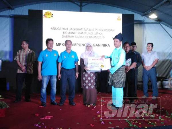 Rodziah menyerahkan anugerah kepada salah seorang Pengerusi Majlis Pengurusan Komuniti Kampung (MPKK) sempena Mini Ekspo Usahawan Selangor dan Karnival Sayangi Desa 2019 Daerah Sabak Bernam di Sabak Sentral Mall semalam.