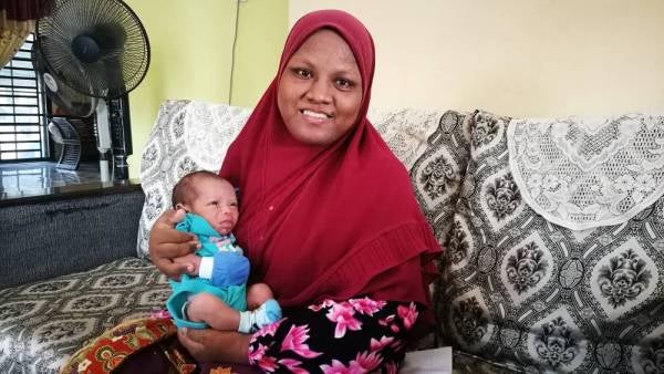 Nur Atikah bersama anak bongsu berusia 15 hari.
