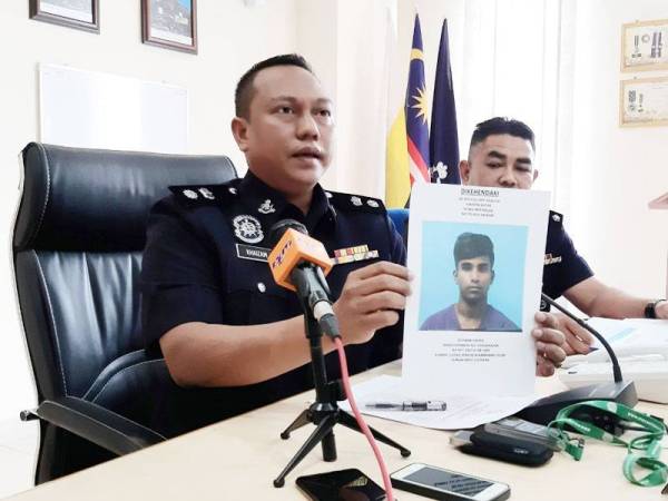 Mohd Khaizam menunjukkan gambar seorang lelaki yang dipercayai geng Appu Boy yang yang terlibat dalam beberapa kes di Sungai Siput.
