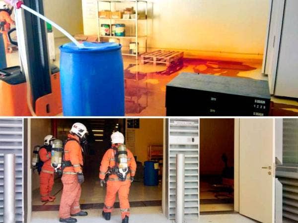 Anggota Hazmat melakukan kerja-kerja pembersihan asid nitrik yang tumpah di dalam bilik stor sebuah kilang di Bayan Lepas pagi tadi.