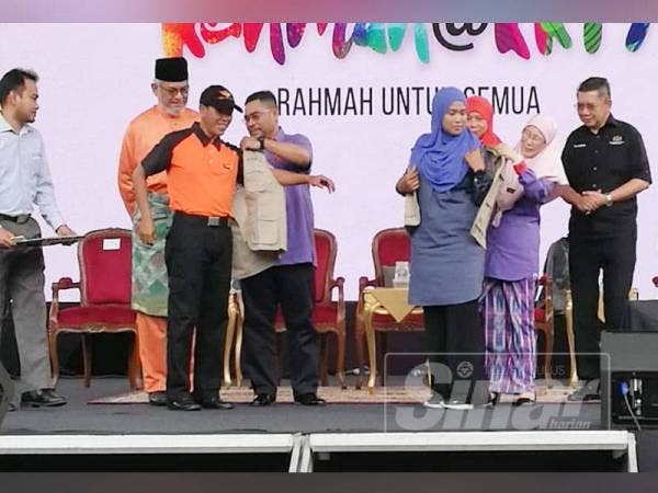 Dr Wan Azizah (dua dari kanan) menyempurnakan upacara pemakaian jaket Sukarelawan Rahmah kepada wakil pertubuhan bersama Mujahid (tiga kiri) pada majlis perasmian Karnival Rahmah 2019 di Dataran Putrajaya, petang ini.