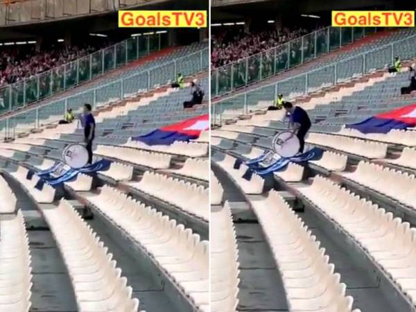 Seorang lelaki tetap mengetuk dram dan melaungkan semangat kepada Pasukan Kemboja walaupun ketika itu Kemboja telah dibelasah teruk oleh Iran.