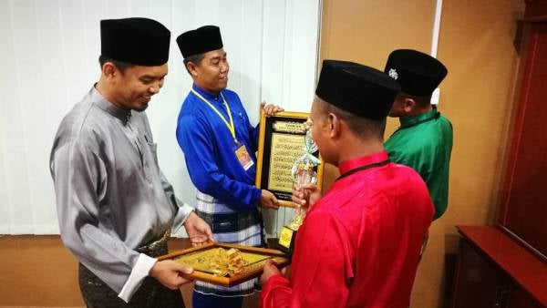 (Dari kanan) Hasri dan Ahmad menunjukkan hadiah dimenangi setelah diumumkan johan tilawah dan syarahan sempena Pertandingan Daie Unggul peringkat kebangsaan di Pusat Pemulihan Dadah Sungai Petani Kedah.
