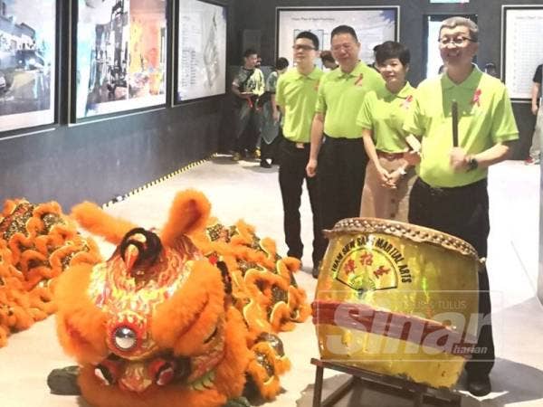 Hock San (kanan) memukul gong sebagai simbolik pelancaran Pangsapuri Melodi Perdana hari ini.