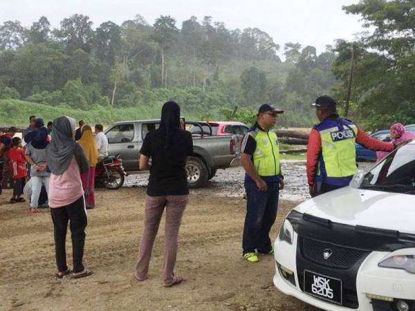 Orang ramai menggerumuni lokasi kejadian.