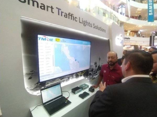 Mukhriz mendengar penerangan berkaitan Smart Trafic Lights Solution selepas merasmikan KED 2019 di Aman Sentral.