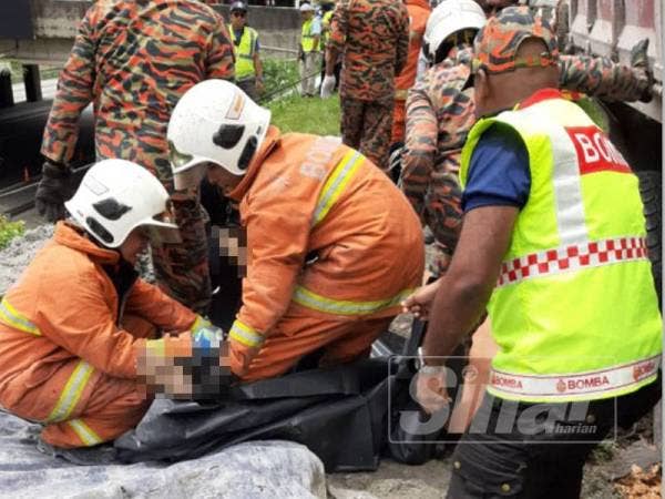 Anggota bomba sedang mengeluarkan mangsa yang tersepit dalam kemalangan di susur keluar Lebuhraya Shah Alam Exspressway (Kesas) pagi tadi.
