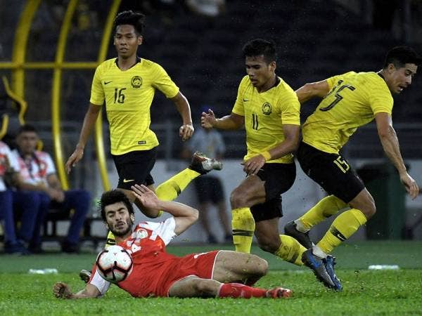Pemain Tajikistan Boboev Sheriddin diasak oleh pemain Malaysia pada perlawanan persahabatan antarabangsa Tier Satu di Stadium Nasional Bukit Jalil malam ini. - Foto Bernama