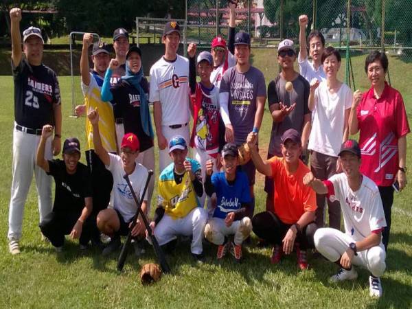 Naruse (berdiri, lima dari kiri) bersorak semangat dengan peserta dan pegawai sebelum mengendalikan klinik besbol di UPM, Serdang.