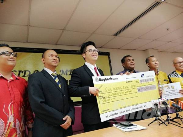 Howard Lee (tiga dari kiri) menyampaikan bantuan peralatan sebanyak RM12,000 kepada Pengetua SMK Gunung Rapat, Roslen Hashim.