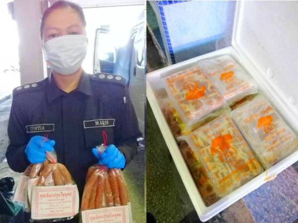 Pegawai Maqis menunjukkan daging babi yang dirampas semasa operasi di Kompleks ICQS Rantau Panjang.