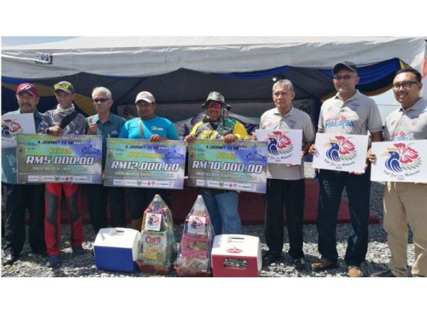 Zulkifly (tiga dari kiri) bergambar bersama pemenang pertandingan memancing di Kuala Sungai Baru semalam.