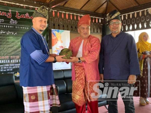 Hafiz (kiri) menyampaikan cenderamata kepada Ariffin sempena perasmian majlis tersebut.