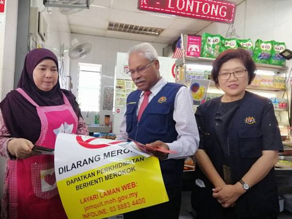 Sivanesan bersama Dr Lay Ming mengedarkan tanda larangan merokok kepada pengusaha premis makanan ketika tinjauan ke Medan Selera Dato' Sagor hari ini.