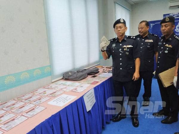 Beng Yeow menunjukkan barang kemas yang dirampas daripada suspek di IPD Kulai.