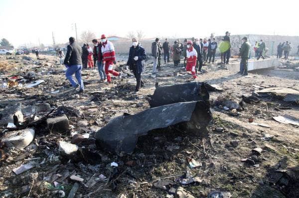 epa08111554 Emergency services personnel walk amidst the wreckage after an Ukraine International Airlines Boeing 737-800 carrying 176 people crashed near Imam Khomeini Airport in Tehran, killing everyone on board; in Shahriar, Iran, 08 January 2020. EPA-EFE/ABEDIN TAHERKENAREH