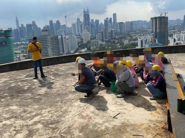 Antara warga asing yang ditahan dalam Ops Kutip di kawasan tapak pembinaan di Jalan Ampang, Kuala Lumpur kelmarin.